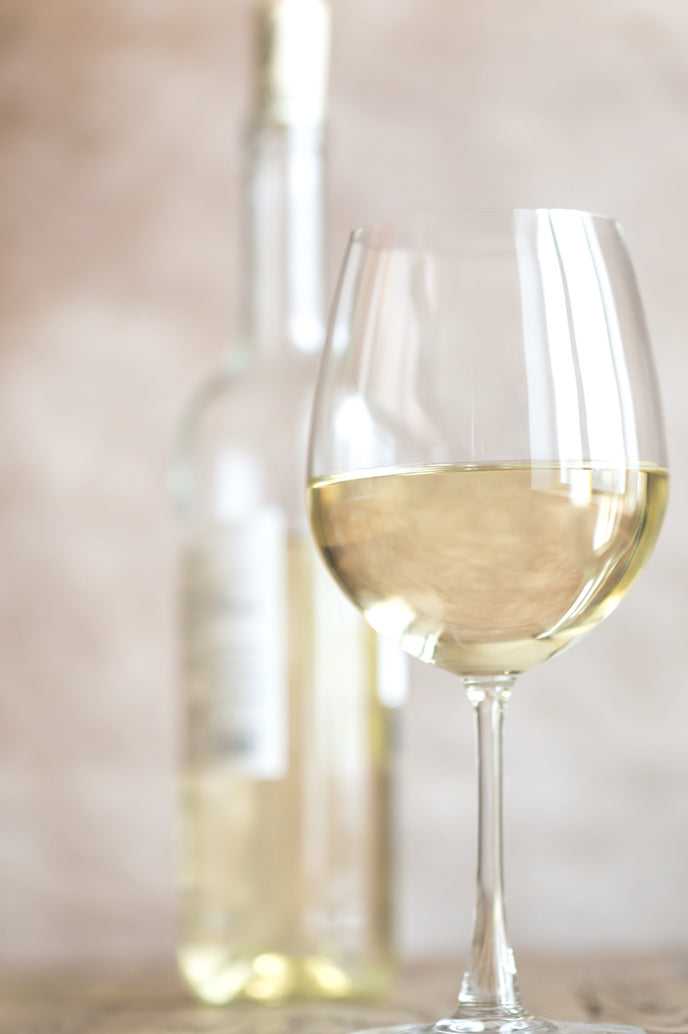 A glass and a bottle of sauvignon blanc