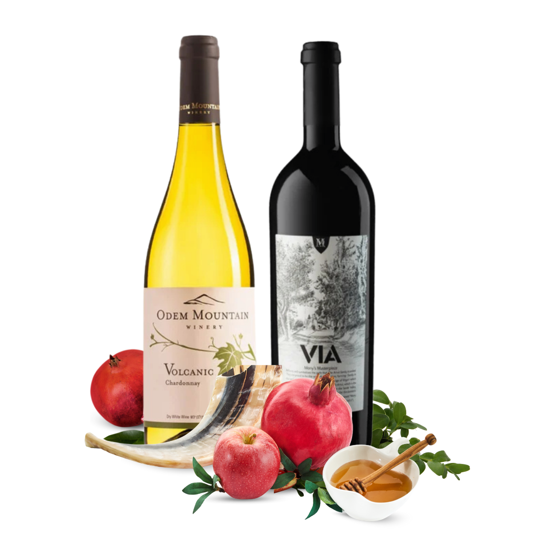 Two wine bottles, one yellow and one black, with pomegranates and apples on a white background.