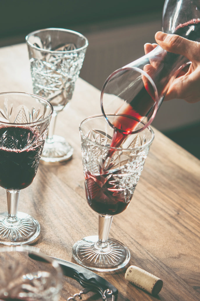 tempranillo being poured on wine glasses