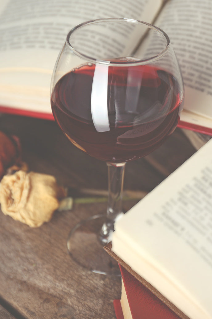 A glass of merlot with books