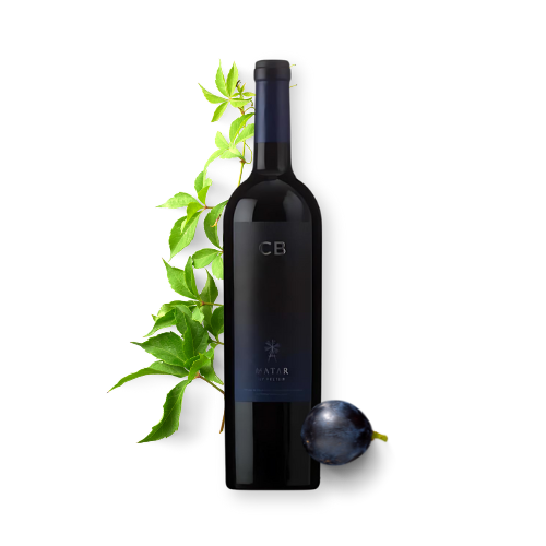 A bottle of Cb Matar wine with green leaves and a black grape in the background.