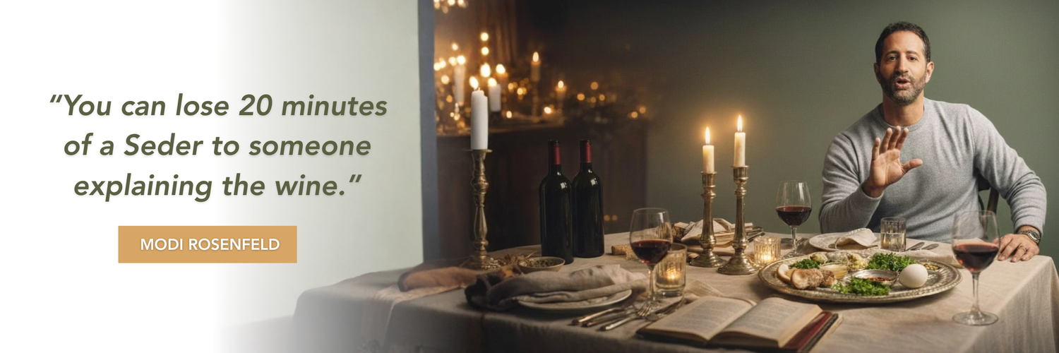 Seder table set with candles, open Haggadah, and red wine bottles and glasses under a warm spotlight. On the right, Modi Rosenfeld gestures mid-conversation. Overlaid quote reads: “You can lose 20 minutes of a Seder to someone explaining the wine.” — MODI ROSENFELD.
