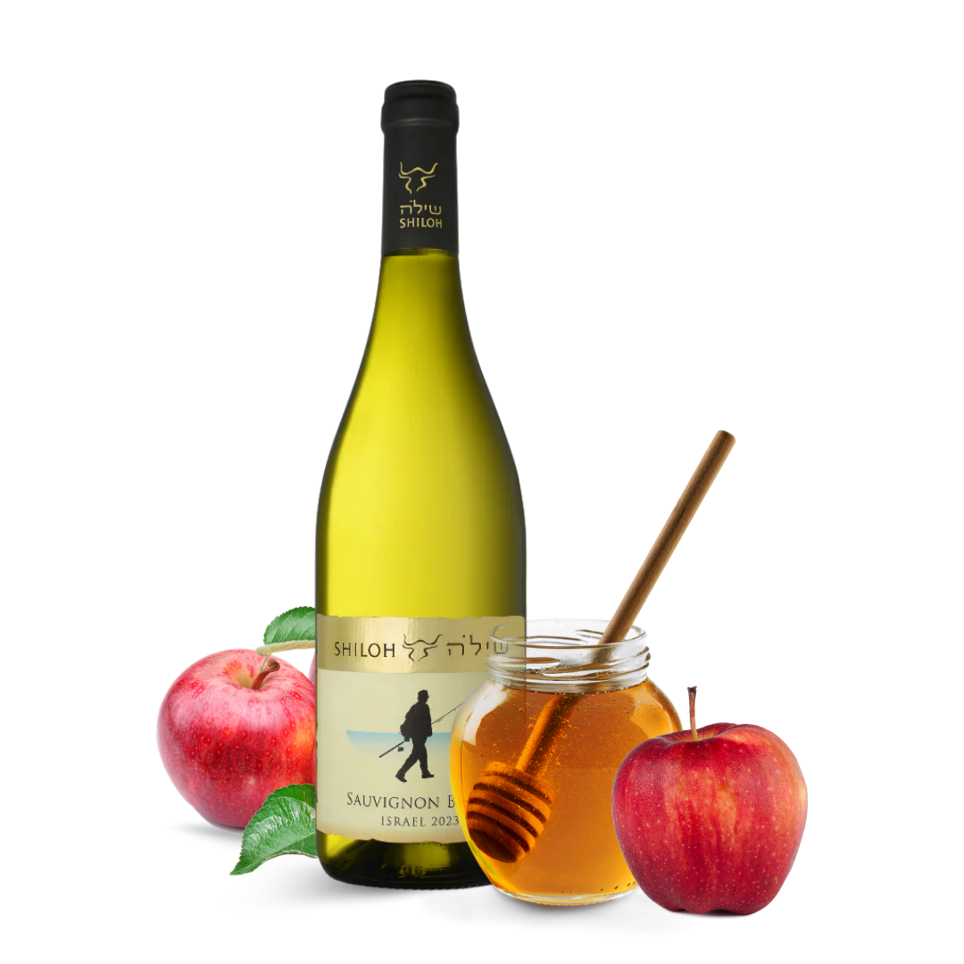 Bottle of Shiloh Sauvignon Blanc wine with apples and a jar of honey on a white background
