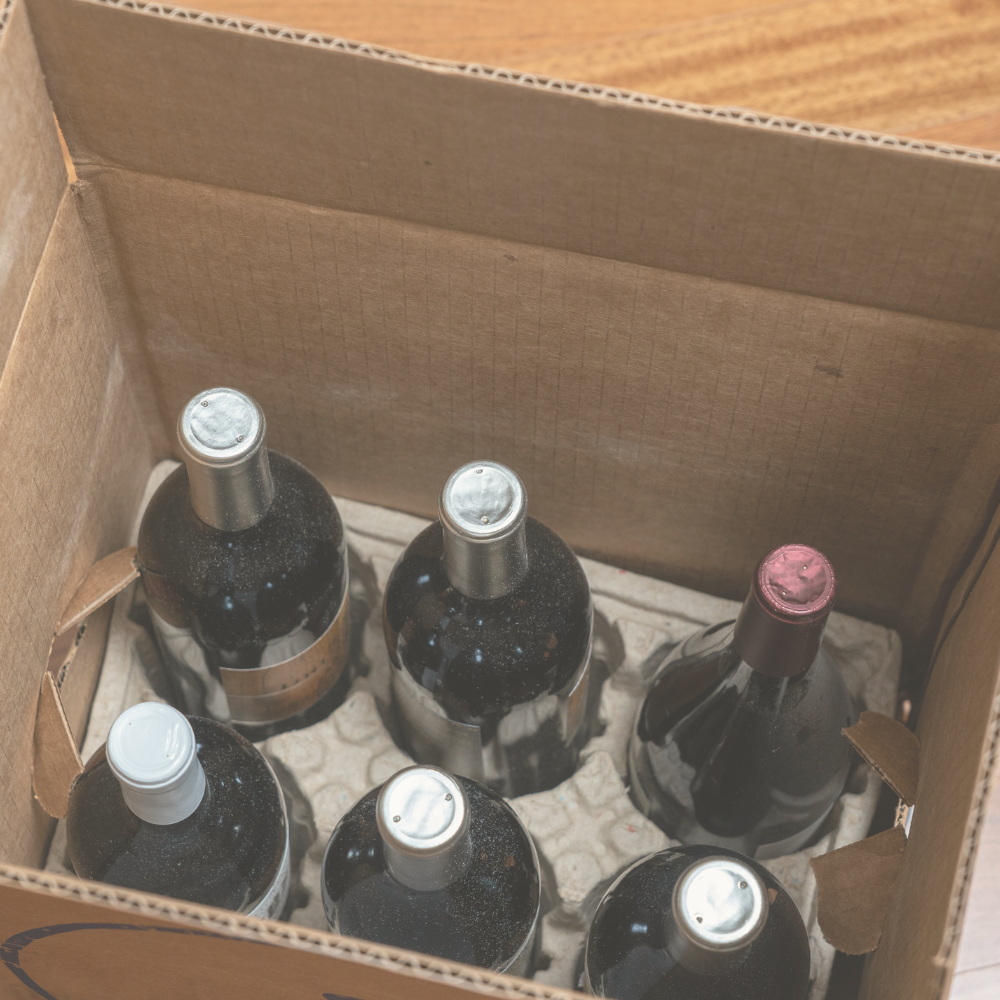 open box of a half-dozen bottles of wine for home delivery
