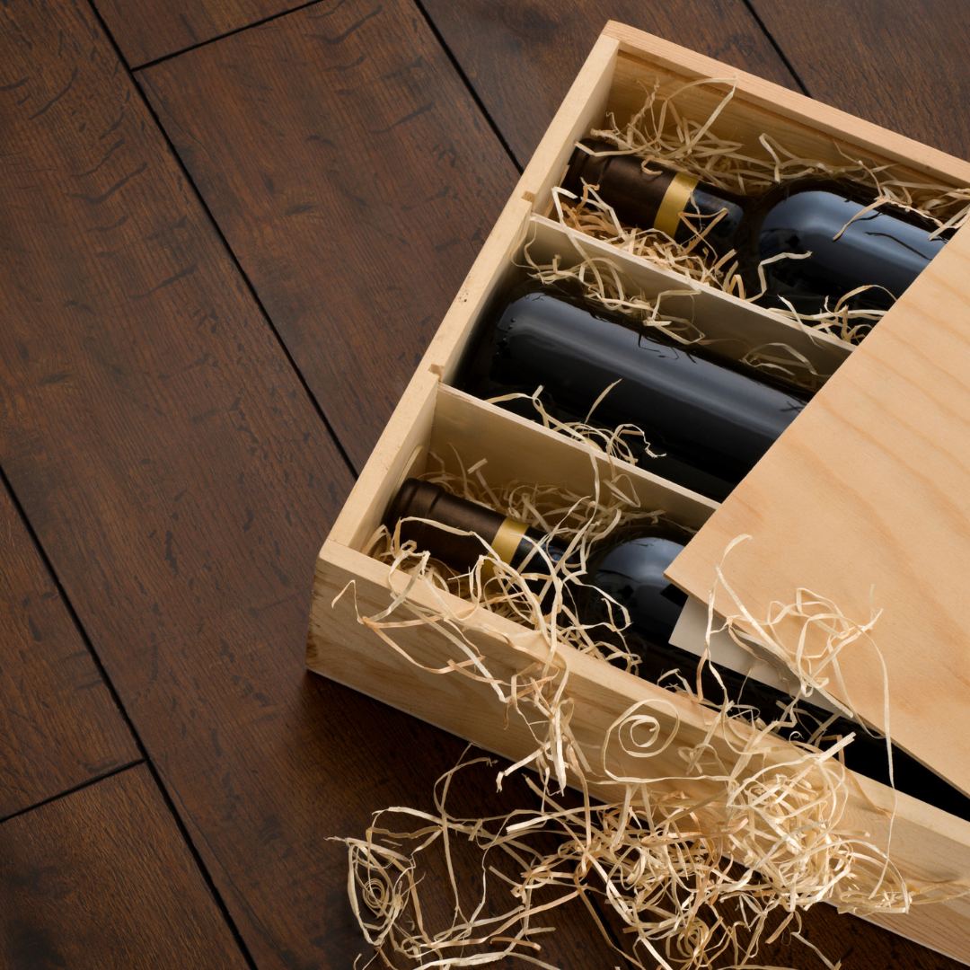 Wooden crate with wine bottles on a wooden floor